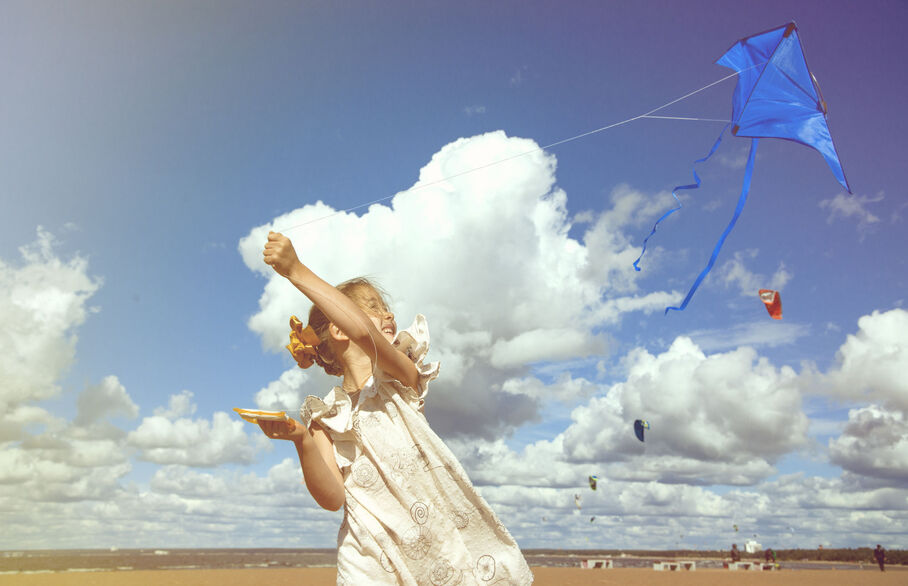 child flying kite