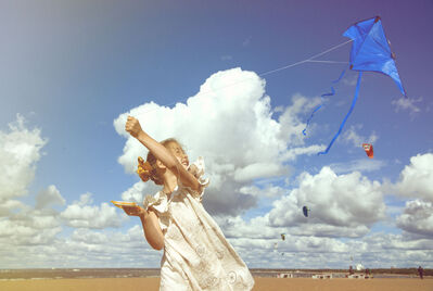 child flying kite