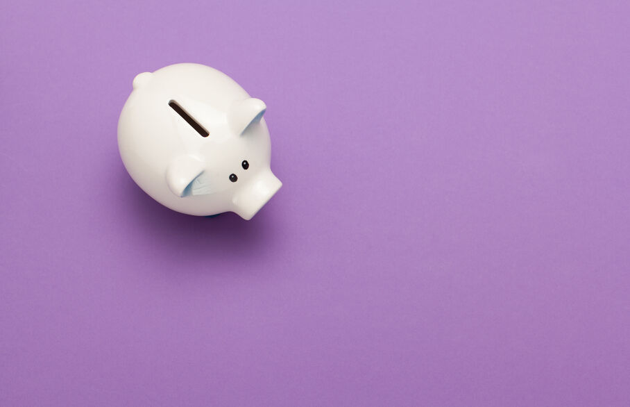 Piggy bank on a plain purple background