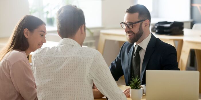 Couple sitting with mortgage adviser
